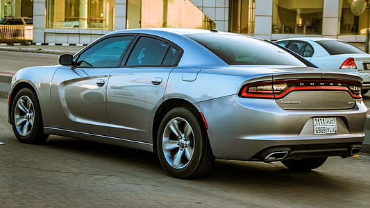 silver Dodge Charger sedan parked near white car thumbnail