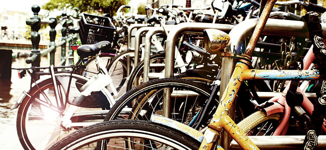 selective focus photo of bicycles park beside black metal fence at daytime thumbnail