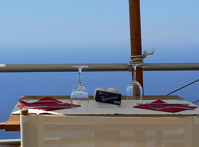 two clear long-stem wine glasses on brown wooden table thumbnail