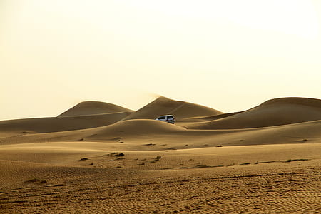 white vehicle traveling at desert thumbnail