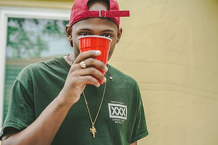 person holding red plastic cup thumbnail