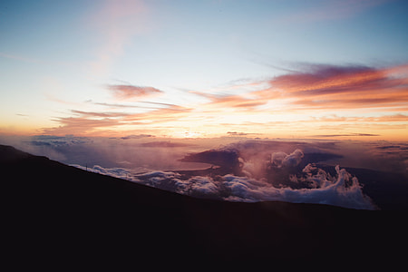 silhouette photo of mountain and white clouds thumbnail