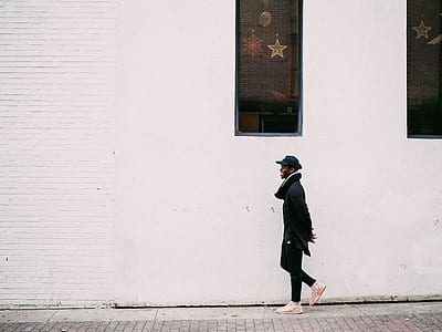 man walking on gray concrete ground thumbnail