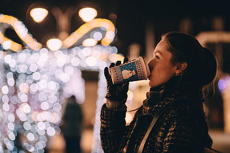 woman drinking on plastic cup in shallow photography thumbnail