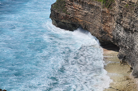 photography of sea waves on brown cliff thumbnail