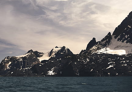 snowy mountain under white clouds thumbnail