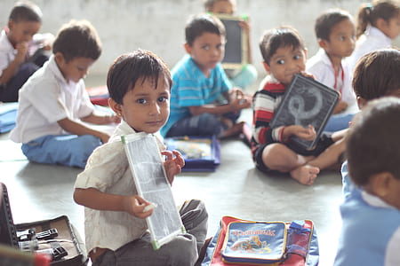 boy holding white paper thumbnail