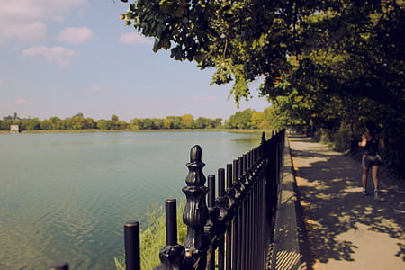 black fence near body of water thumbnail