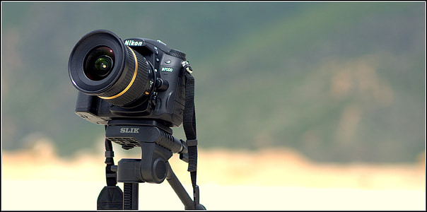 black Nikon DSLR camera mounted on black stand thumbnail