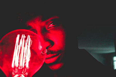 Portrait of man by light bulb thumbnail