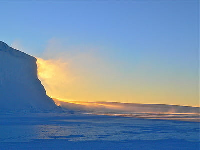 Silhouette of Mountain Beside Body of Water during Sunrise thumbnail