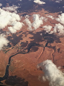 aerial view of body of water in the middle of rock formation during cloudy day thumbnail