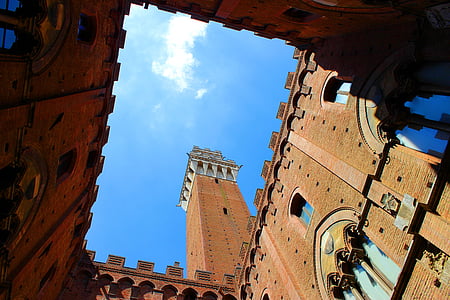 worm's eye view photography of brown concrete tower thumbnail