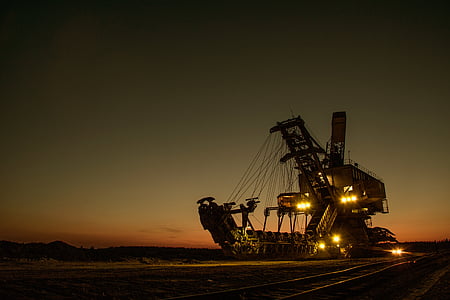 brown heavy machinery with lights during golden hour thumbnail