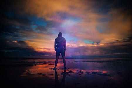 shallow depth of field photography of man standing in the middle of field thumbnail