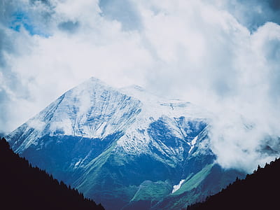 mountain range covered with snow and fog thumbnail
