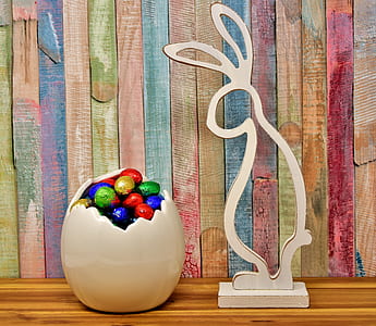 white wooden rabbit and assorted-color eggs thumbnail