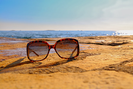 tortoiseshell framed sunglasses on brown sand thumbnail