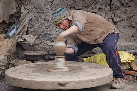 man making clay pot thumbnail