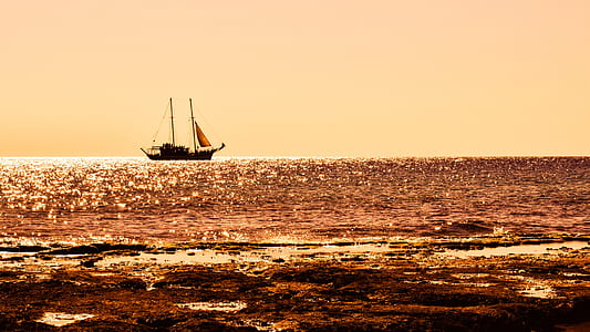 black sailboat on body of water thumbnail