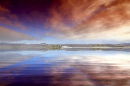 long angle photography of island under red clouds thumbnail