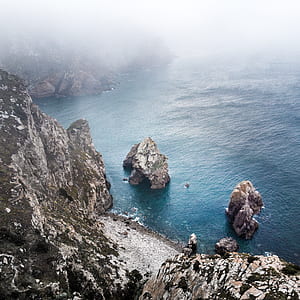 gray rock formation near ocean thumbnail