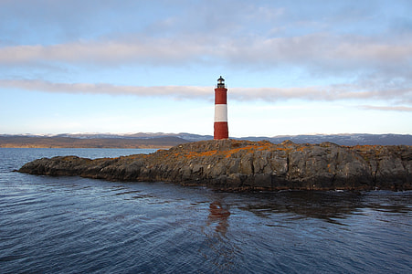 red and white lighthouse in the middle of sea thumbnail
