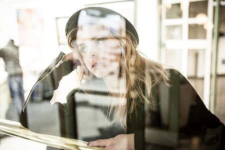 woman leaning against gray surface thumbnail