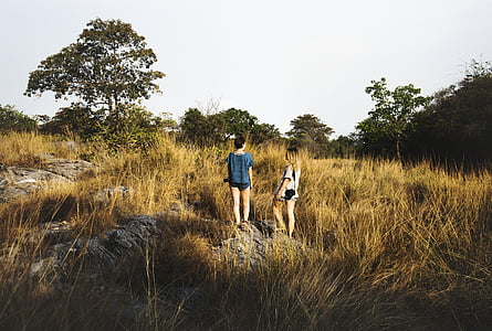 man and woman standing on green grass field thumbnail