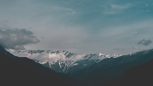 snow covered mountain under cloudy sky thumbnail