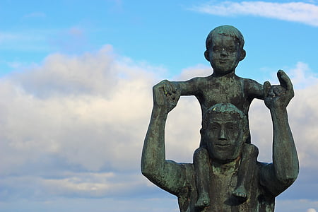 boy on man's shoulder ceramic figurine thumbnail