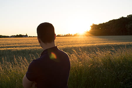 man standing on green field thumbnail
