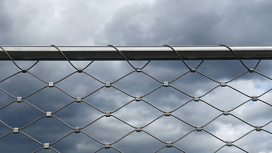 grey cyclone fence under the cloudy sky thumbnail
