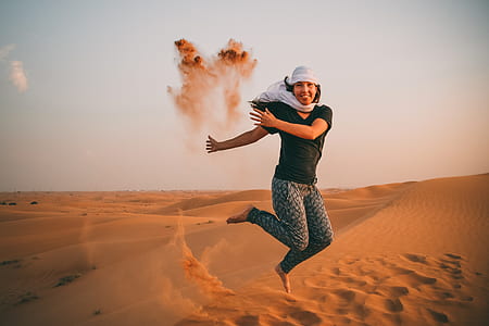 woman doing jump shot photography in desert thumbnail
