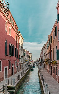river between brown concrete buildings thumbnail