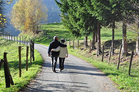 man and woman waling in middle of street thumbnail