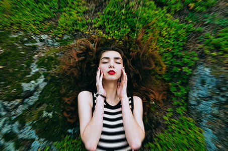 woman in white and black stripe tank top lying on grass thumbnail