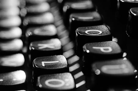 close-up and grayscale photography of typewriter keys thumbnail