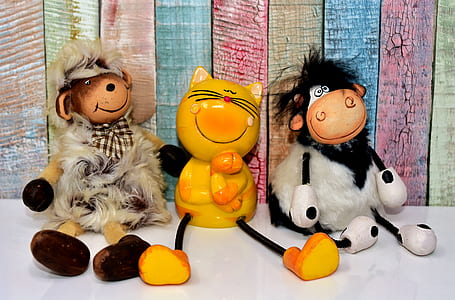 three assorted-color toys on tabletop thumbnail