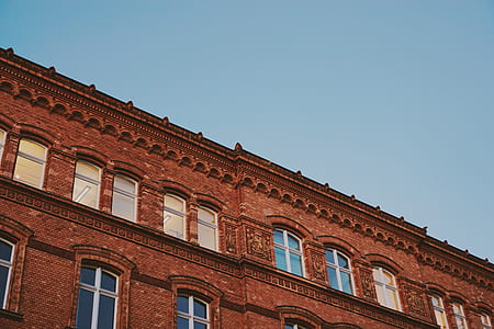 low angle photography of brown high-rise buildin during daytime thumbnail