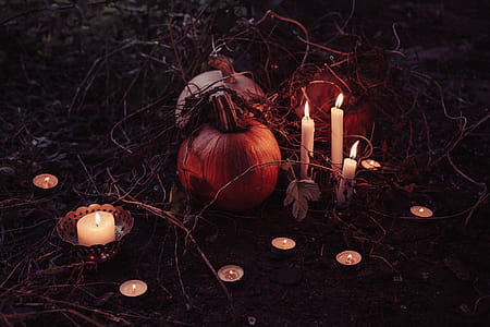 Jack O Lantern Beside Candles Halloween Decor thumbnail