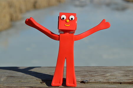 red character figurine on wooden surface thumbnail