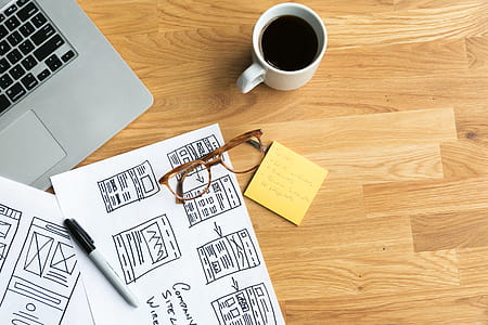 Designer's Desk With Coffee And Wireframes Photo thumbnail