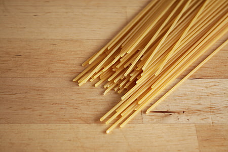 yellow pasta on brown wooden board thumbnail