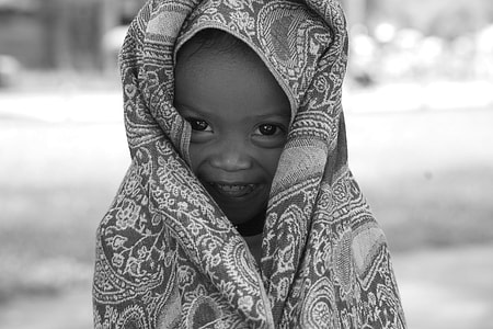 grayscale photo of child covered with textile thumbnail