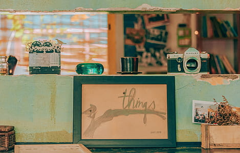 Camera on Top of Shelf Near Photo Frame thumbnail