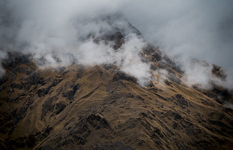 mountain covered with fog during daytime thumbnail