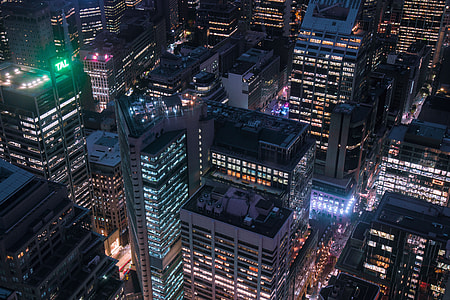 Aerial shot of city buildings at night thumbnail