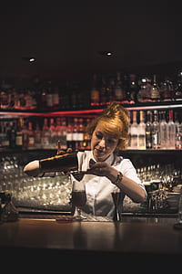 tilt-shift lens photography of woman making cocktails thumbnail