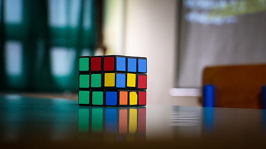 multicolored 3x3 Rubik's cube on wooden surface thumbnail